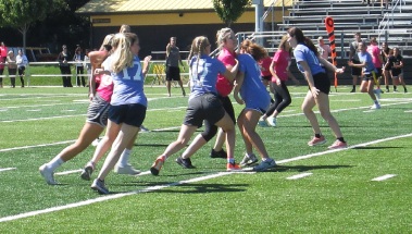 Junior offensive line tries to hold back the senior girls.